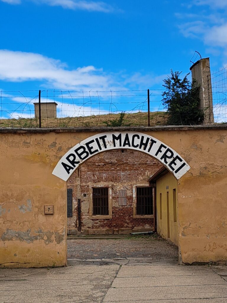 German Sign hanging over enterance to small fortress, Terezin. "Work Makes you free"