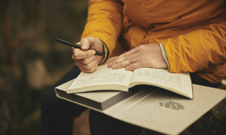 Someone writing in journal for the Artist's Way