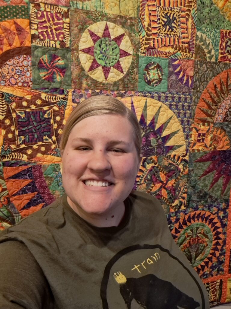 Mack in front of a quilt